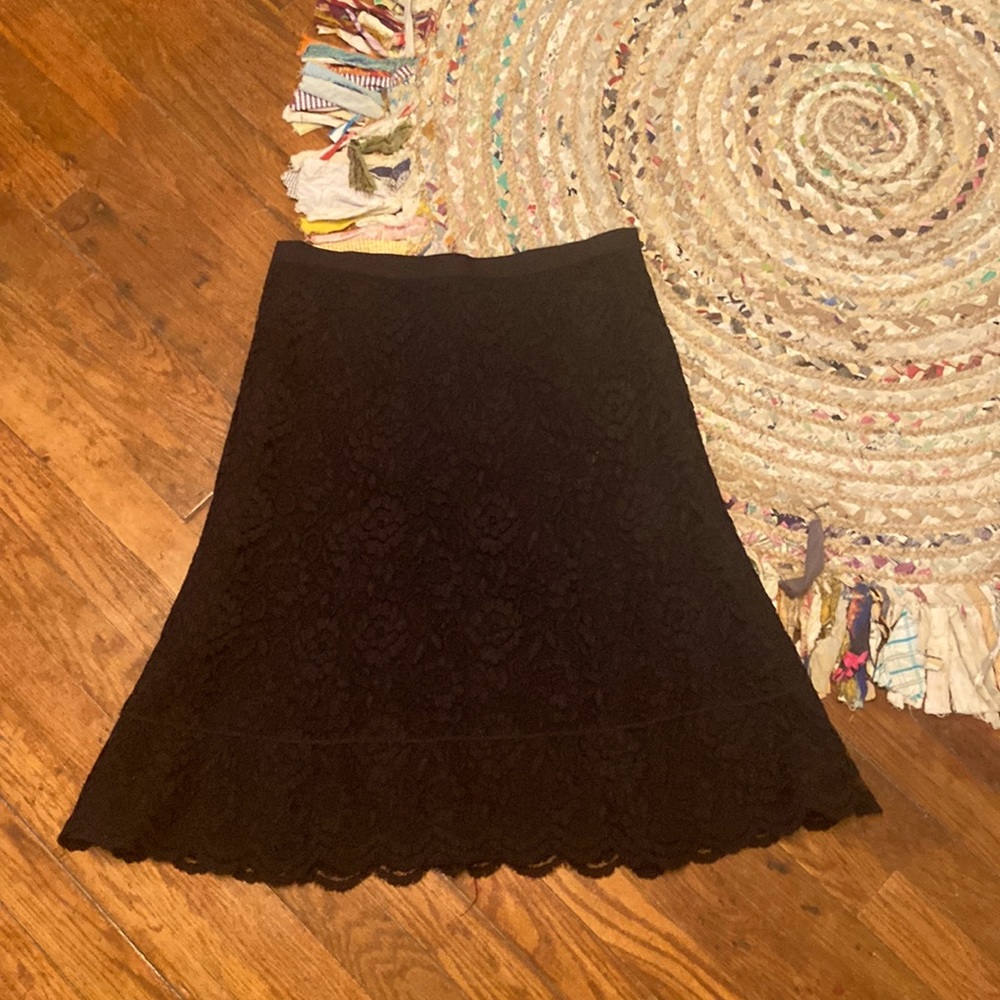 Black, fully lined, lace skirt.